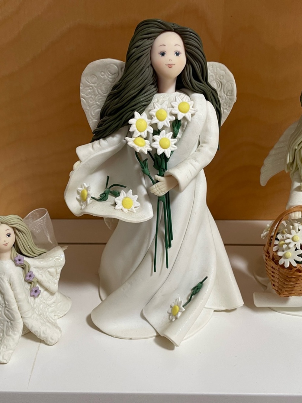 White Angel Figurine Holding Daisies